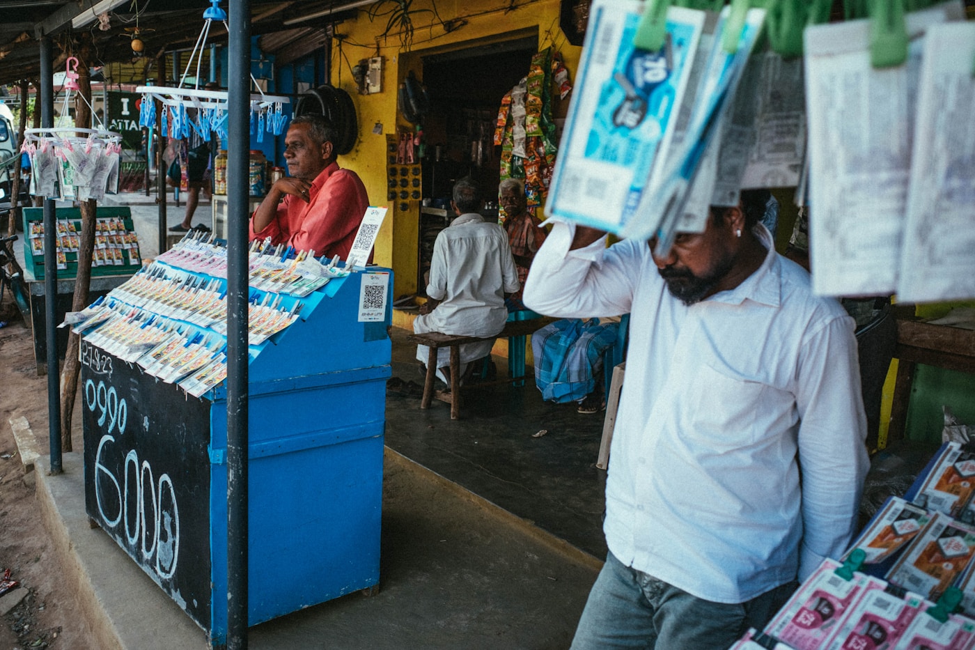 For most newspaper vendors, subscriber records still live in notebooks and memory · Photo: Unsplash